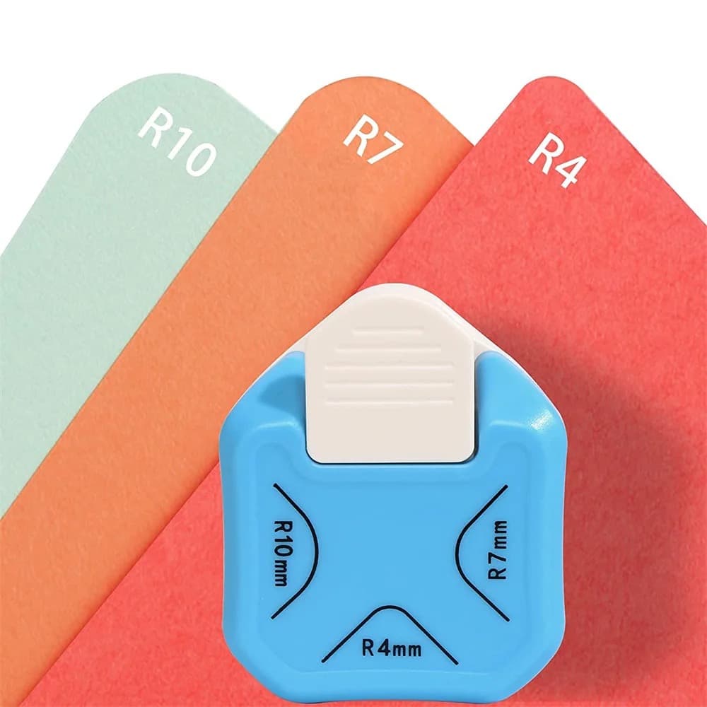 Perforatrice à coins bleue posée devant trois cartes de papier vert, orange et rouge marquées R10, R7 et R4.